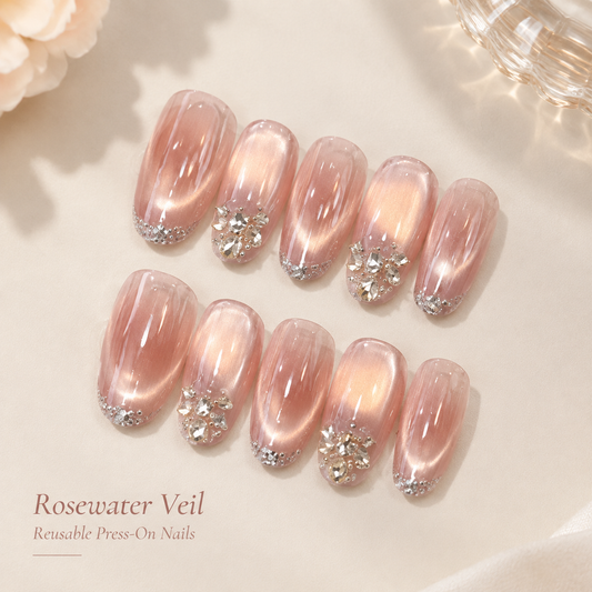 Rosewater Veil rose-pink cat-eye press-on nails with crystal accents on a soft cream background